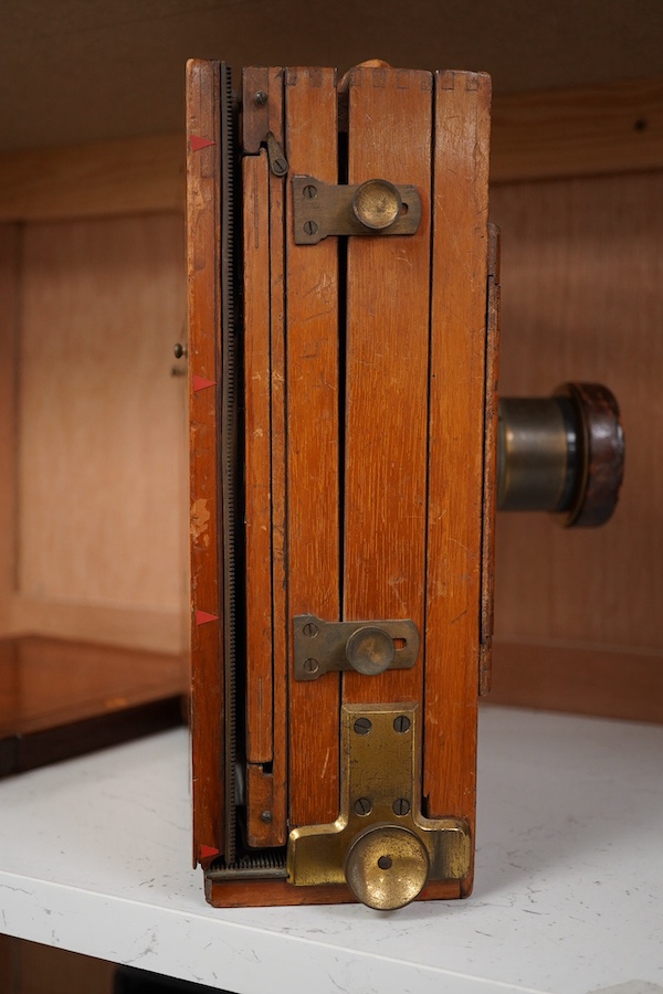 An early 20th century brass mounted mahogany full plate camera, together with a glass negative holder. Condition - fair to good.